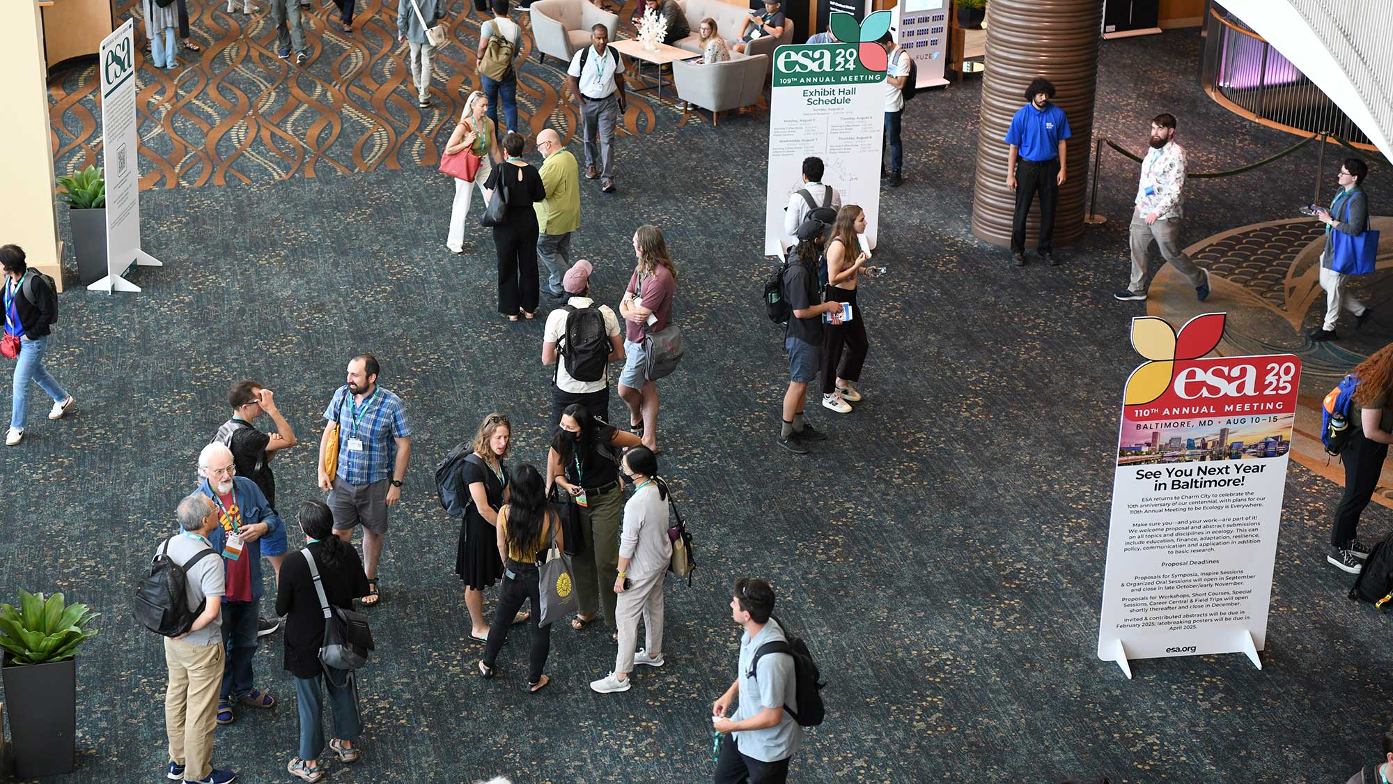 Attendees move across the convention center.