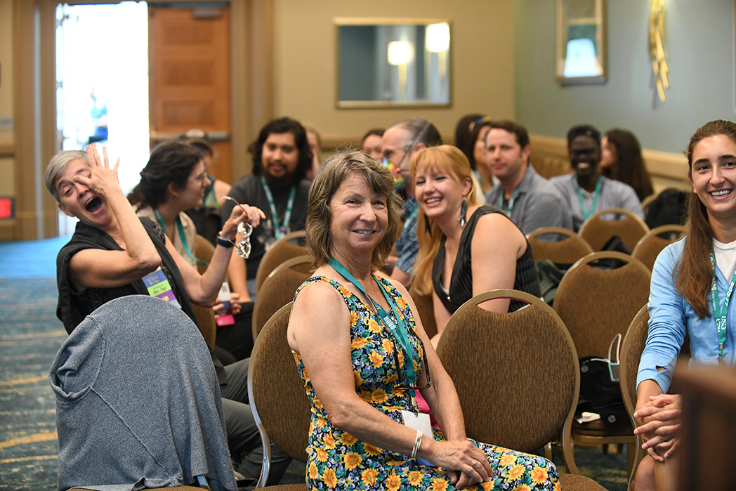 An audience poses for the photo.