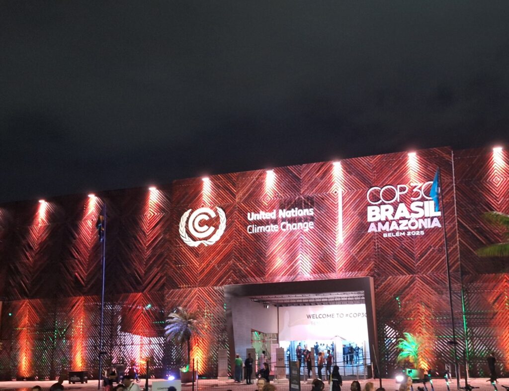 The front of a convention hall with "United Nations Climate Change" and "COP30 Brasil Amazonia" displayed.