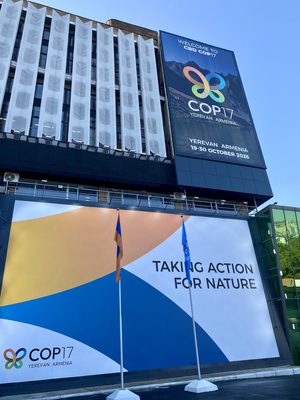 A large building is covered with banners displaying the COP17 logo and the words, "Taking action for nature."
