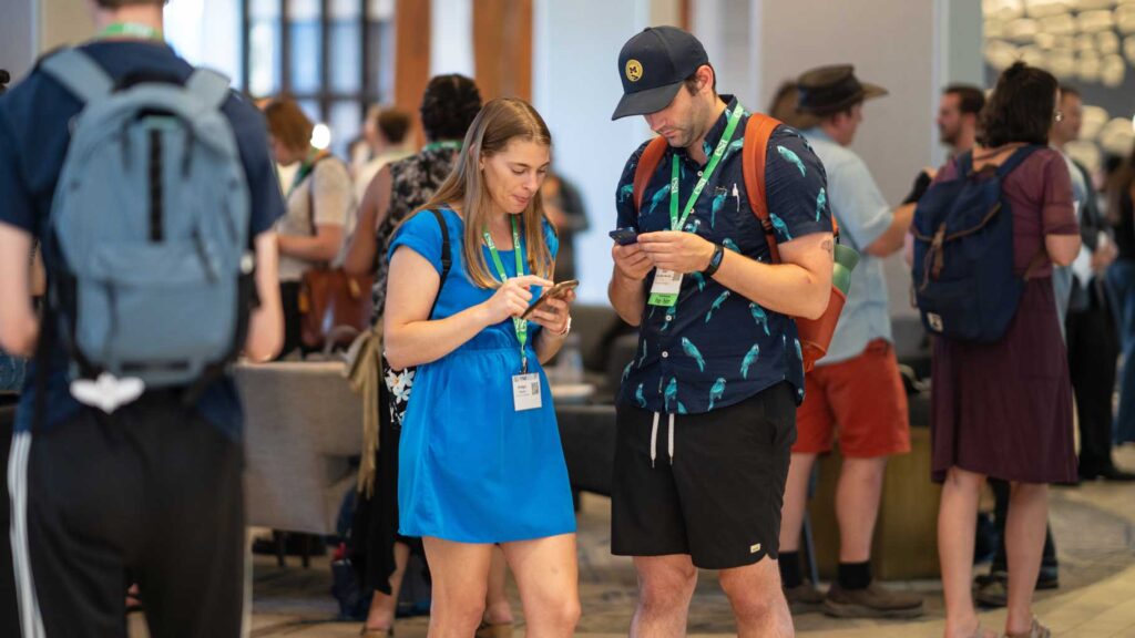 Two attendees explore the Annual Meeting schedule.