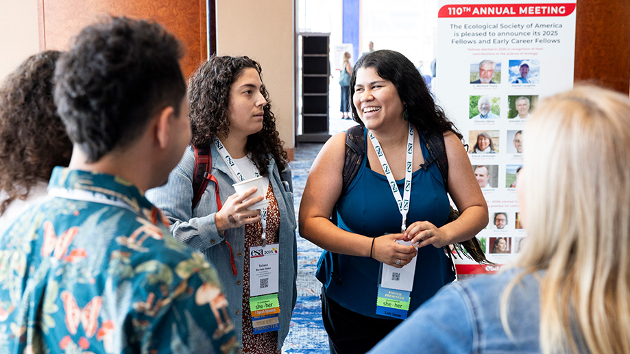 A group of participants laugh during a conversation.