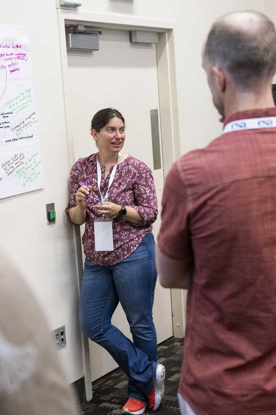 A presenter listens to their audience.