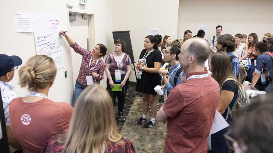 A workshop presenter explains their work.