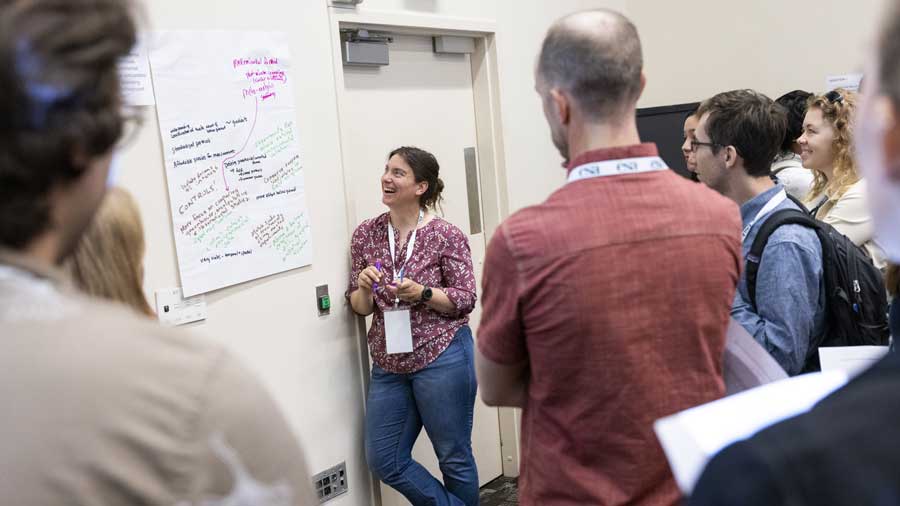A presenter references her white board.