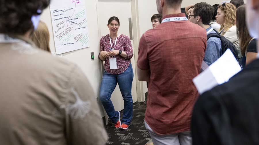 A presenter listens to her audience.