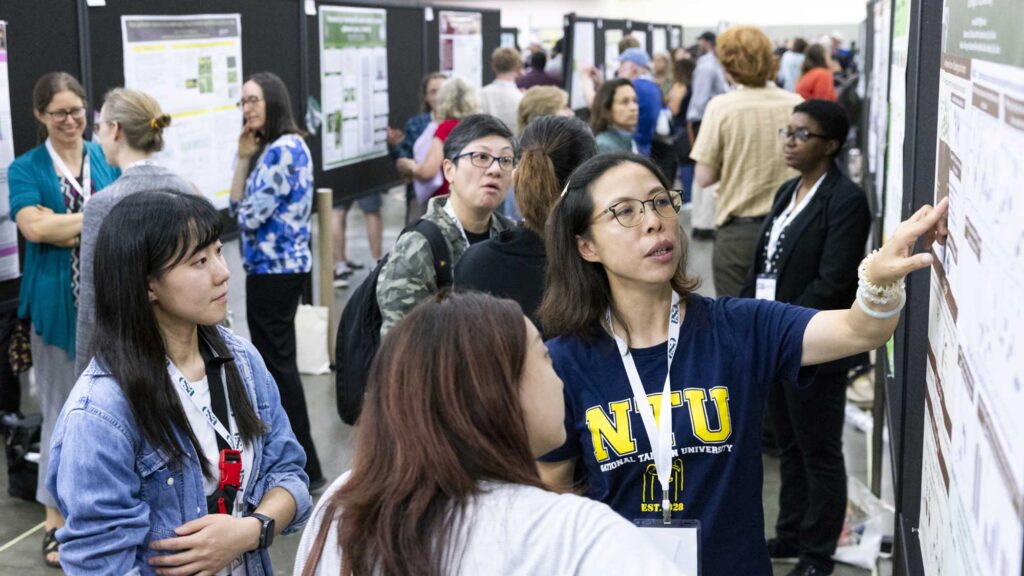 A group of attendees look at a presentation.