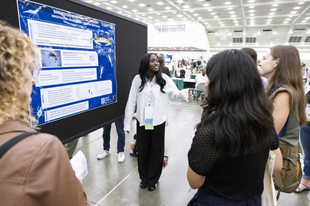 A speaker reacts to an audience members reaction to their poster.