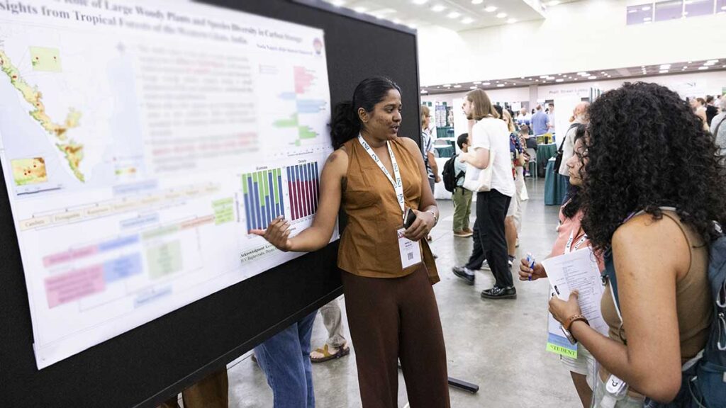 A presenter explains their poster.