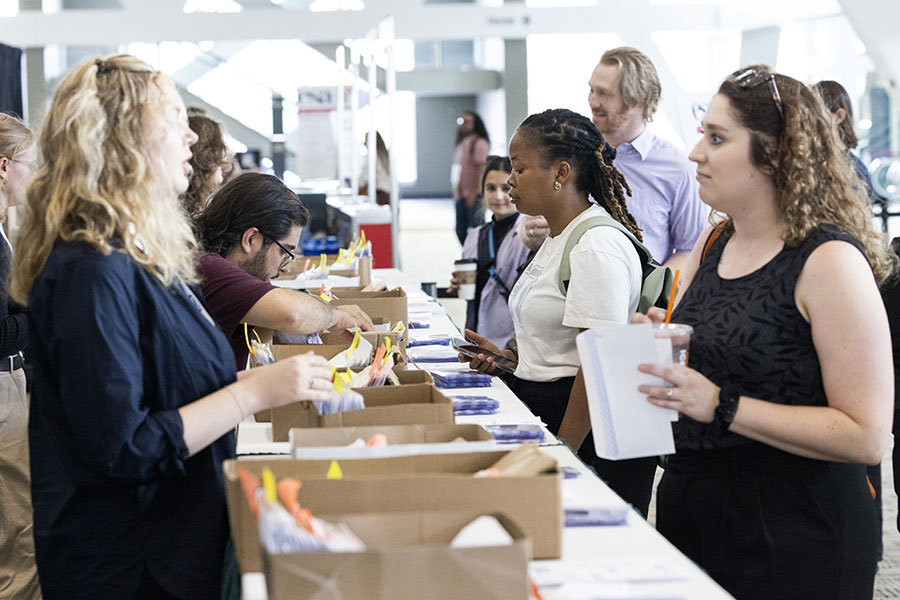 Attendees get their badges at registration at last year's annual meeting. 