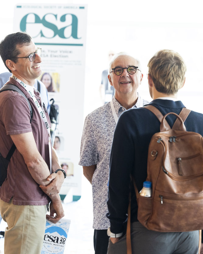 Osvaldo Sala chats with a few meeting attendees.