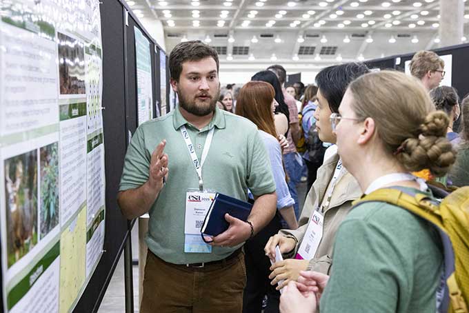 A poster presenter explains his findings. 