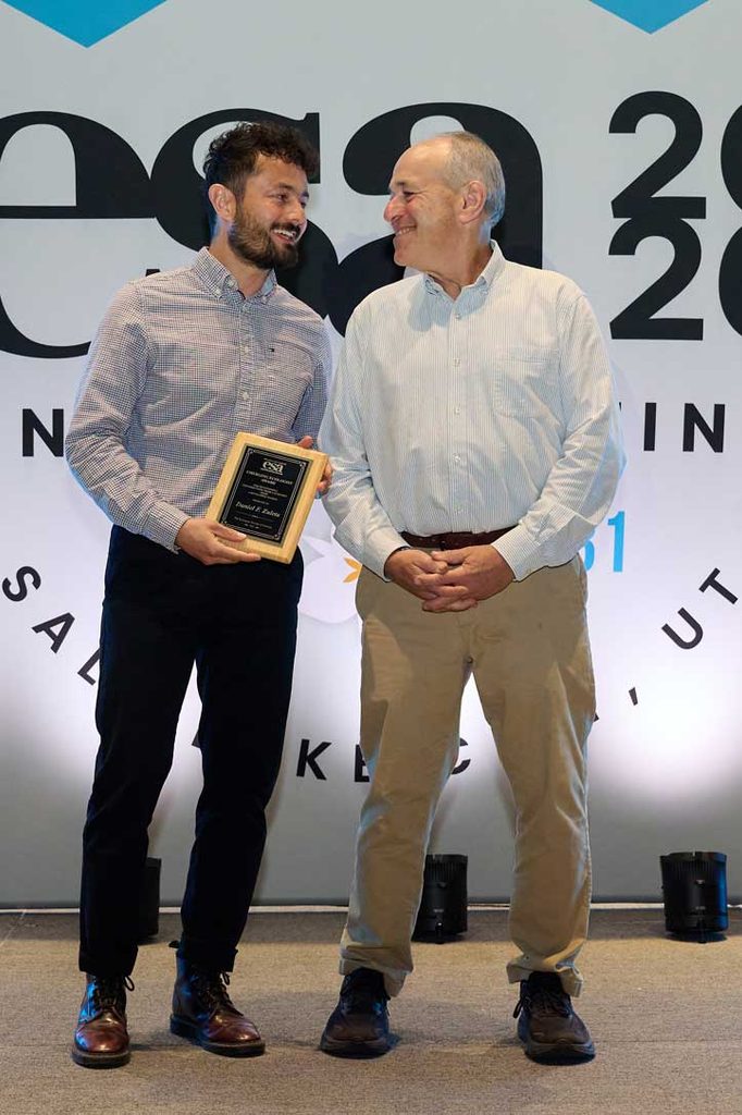 An award winner shares a smile with the presenter. 