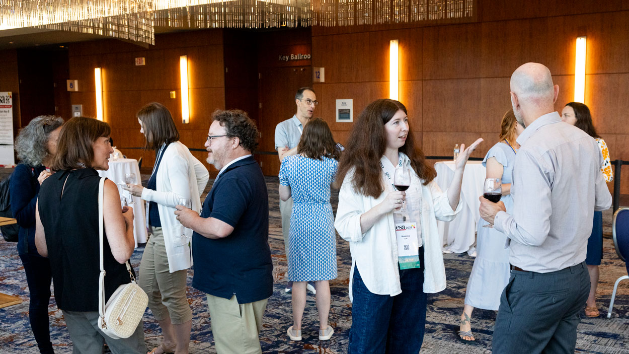 A group of attendees chat with staff.