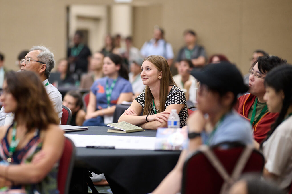 An attendee smiles while participating in a session.