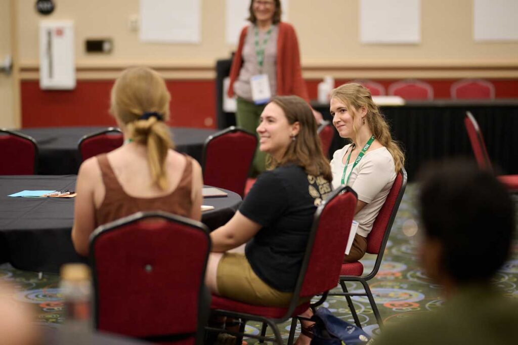 A few lady attendees share a smile during a session. 