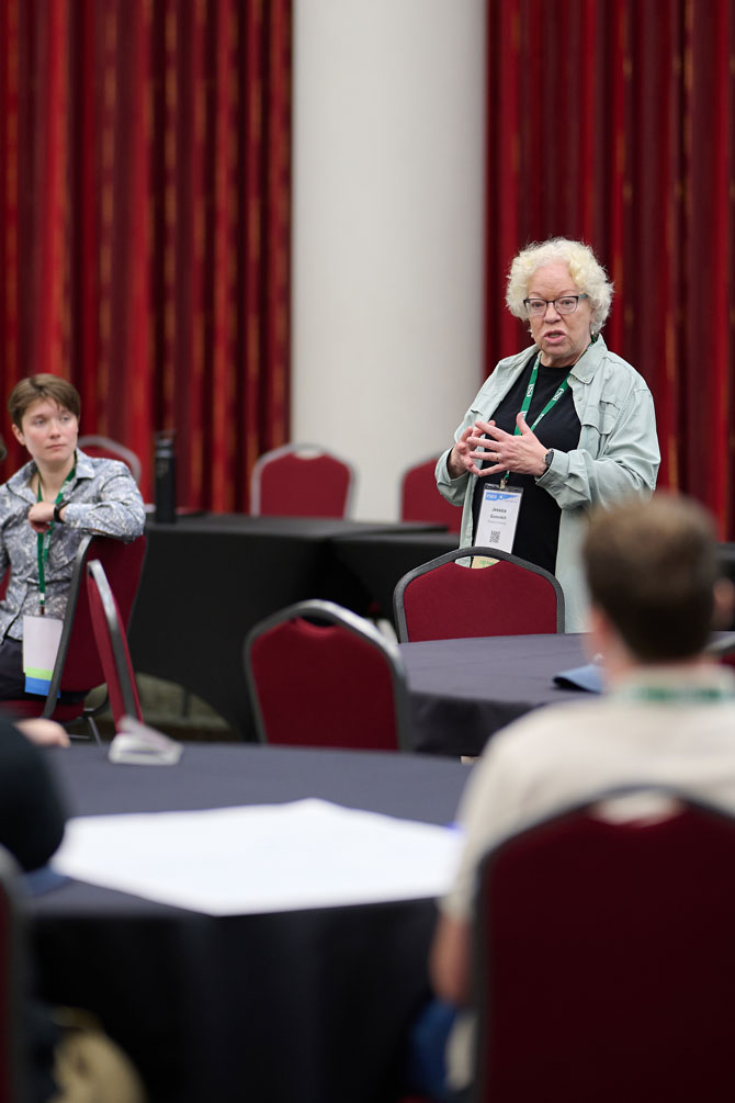 A presenter discusses their findings in front of a smaller audience.