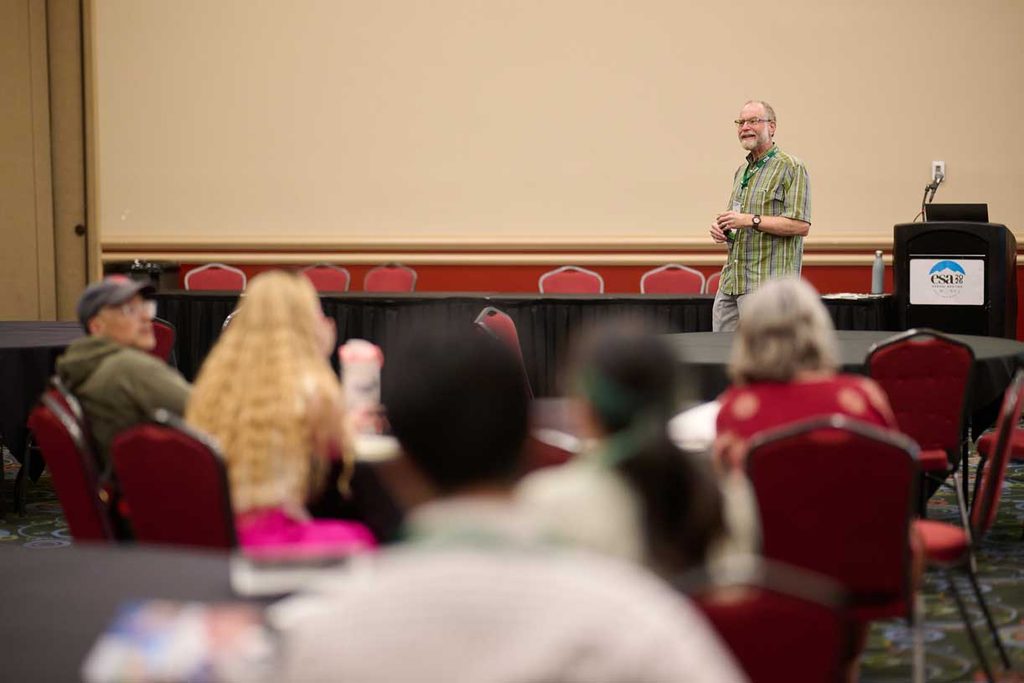 A speaker presents before an audience.
