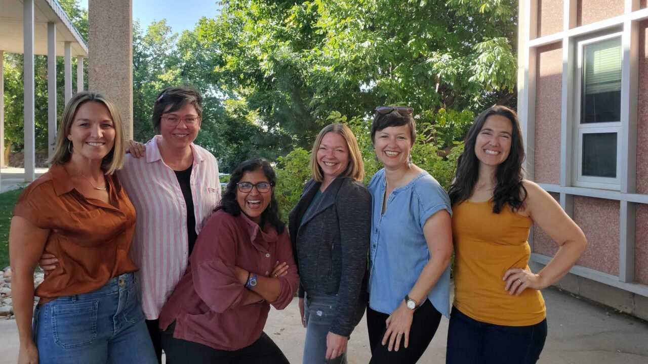 Women leaders of the communication and engagement section stand for a photo.